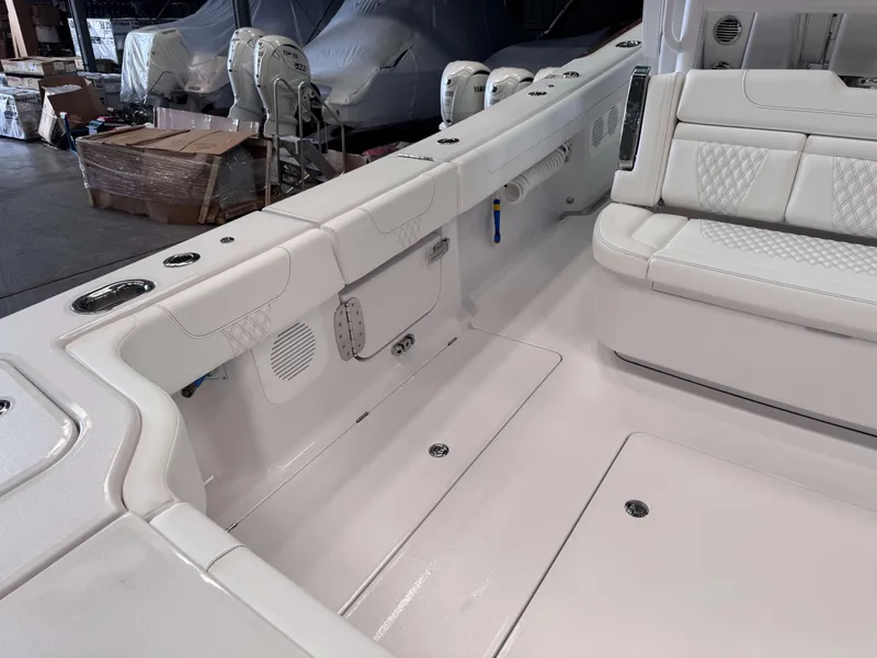 Slide: The Image of 2025 Phenom 37 CC boat interior with white seating and storage compartments. - 10