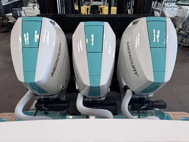 Slide: The Image of 2025 Phenom 37 CC with triple Mercury outboard engines in a workshop setting. - 11