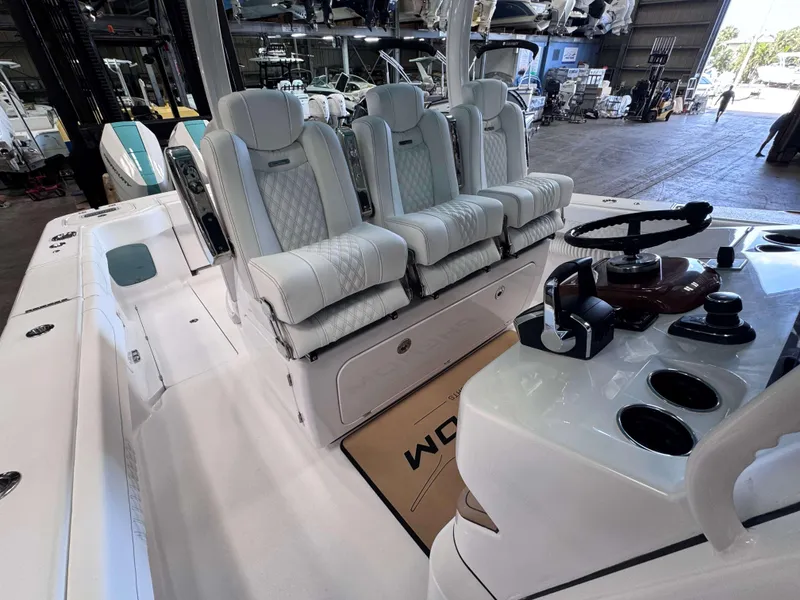 Slide: The Image of 2025 Phenom 37 CC boat interior with luxury seating and modern controls. - 15