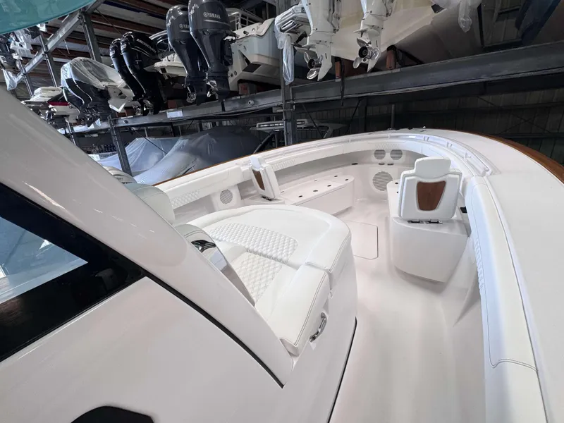 Slide: The Image of 2025 Phenom 37 CC boat interior with white seating and modern design. - 16