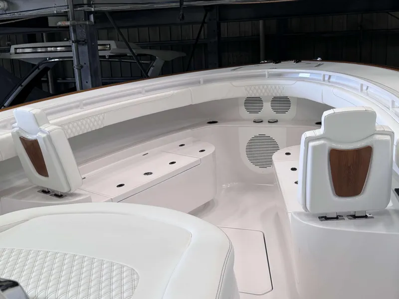 Slide: The Image of 2025 Phenom 37 CC boat interior with white seating and wood accents. - 17
