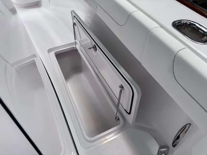 Slide: The Image of Phenom 37 CC 2025 boat storage compartment with open hatch and sleek design. - 18
