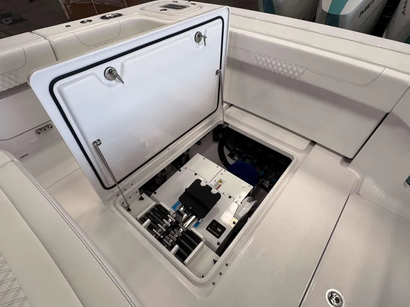 Slide: The Image of 2025 Phenom 37 CC boat storage compartment with open hatch, showcasing interior details. - 22