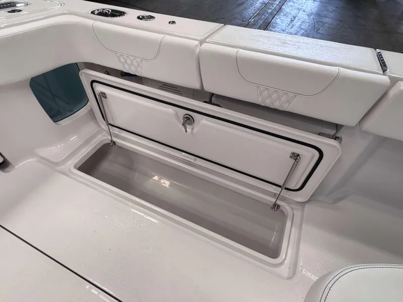 Slide: The Image of Phenom 37 CC 2025 boat storage compartment with cushioned seating. - 24