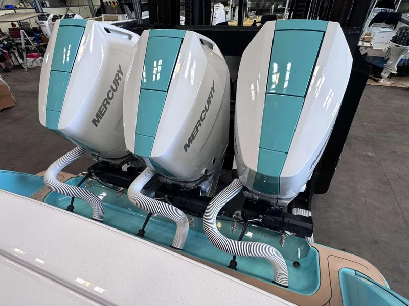 Slide: The Image of 2025 Phenom 37 CC with triple Mercury outboard engines in a showroom. - 25