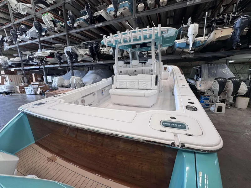 Slide: The Image of 2025 Phenom 37 CC boat in storage, showcasing sleek design and spacious deck. - 6