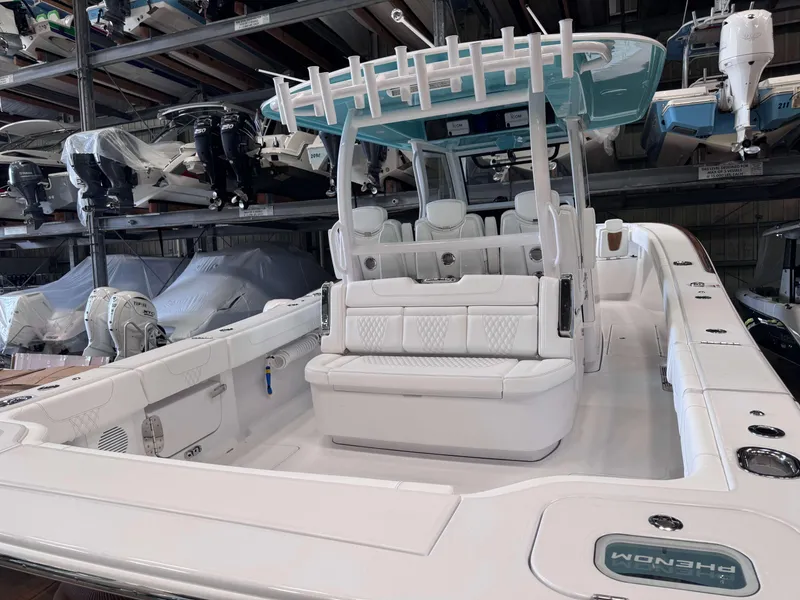 Slide: The Image of 2025 Phenom 37 CC boat in storage, showcasing sleek white interior and seating. - 7