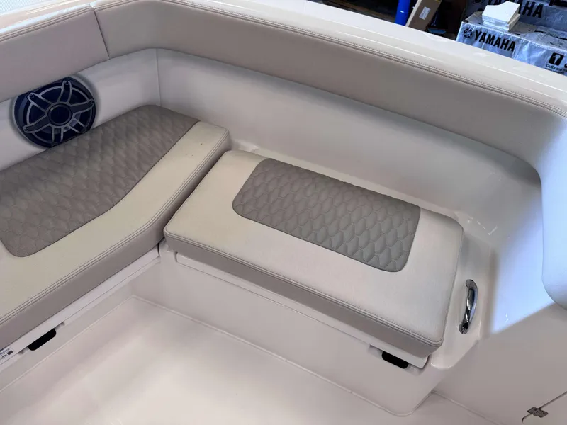 Slide: The Image of 2025 Solace 32 CS boat interior seating with speaker and storage. - 15