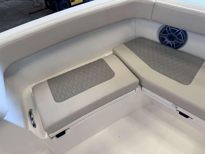 Slide: The Image of 2025 Solace 32 CS boat interior with cushioned seating and speaker. - 16