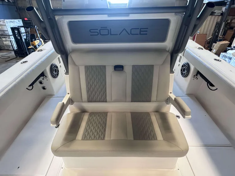 Slide: The Image of Solace 32 CS 2025 boat interior with cushioned seating and speaker system. - 17