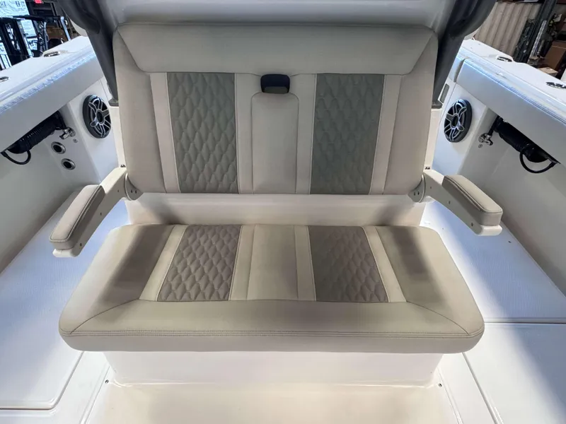 Slide: The Image of Luxurious seating on 2025 Solace 32 CS boat with quilted upholstery and armrests. - 18