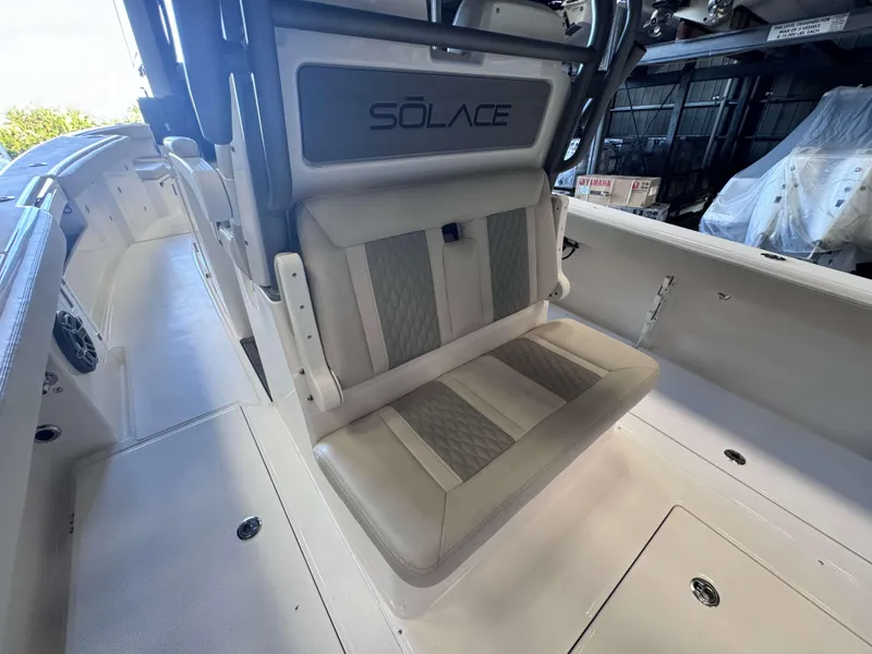 Slide: The Image of 2025 Solace 32 CS boat interior with cushioned seating and sleek design. - 19