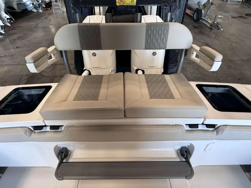 Slide: The Image of 2025 Solace 32 CS boat seating with dual outboard engines in a workshop setting. - 21