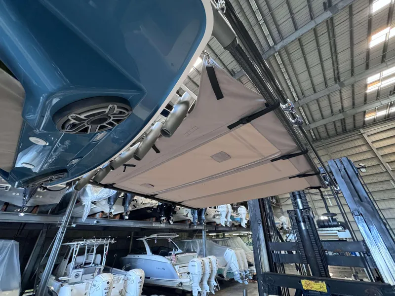 Slide: The Image of 2025 Solace 32 CS boat in storage, viewed from below, showcasing hull and equipment. - 22