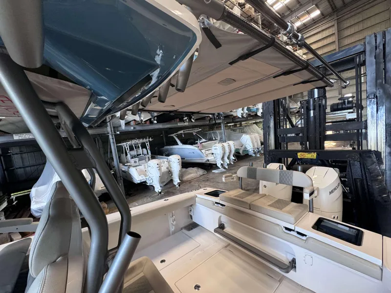 Slide: The Image of 2025 Solace 32 CS boat in storage facility with multiple outboard engines. - 23