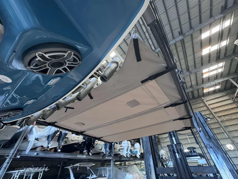 Slide: The Image of 2025 Solace 32 CS boat in storage, showcasing underside and speaker system. - 24