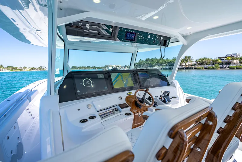 Slide: The Image of 2025 HCB 65 Estrella boat cockpit with advanced navigation system and luxurious seating. - 12