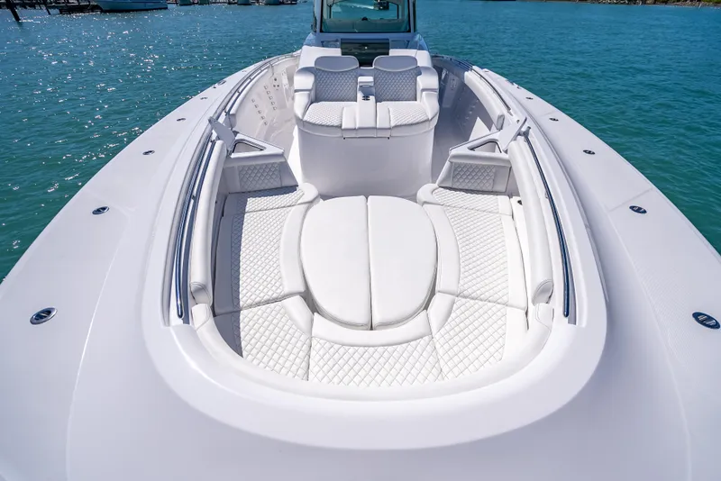Slide: The Image of 2025 HCB 65 Estrella luxury boat with spacious white seating on clear blue water. - 16