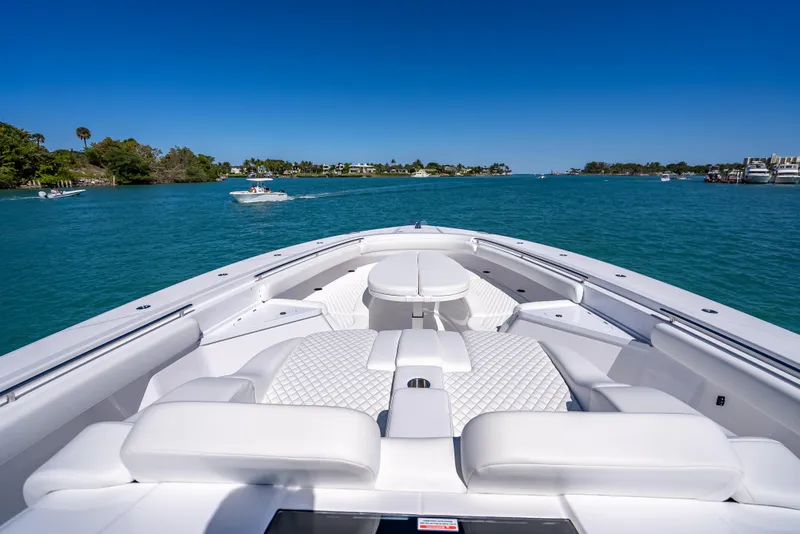 Slide: The Image of 2025 HCB 65 Estrella luxury boat cruising on clear blue waters. - 17