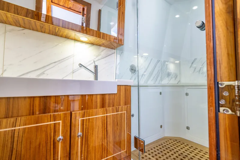 Slide: The Image of Luxurious bathroom interior of 2025 HCB 65 Estrella yacht with wood accents and glass shower. - 23