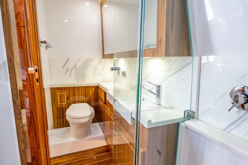 Slide: The Image of Luxurious bathroom in 2025 HCB 65 Estrella yacht with modern fixtures and wood accents. - 24