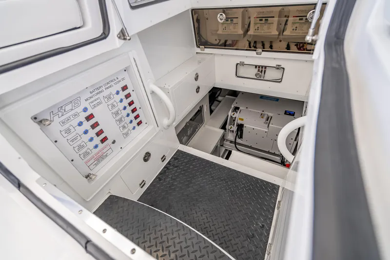 Slide: The Image of 2025 HCB 65 Estrella boat interior, featuring control panels and storage compartments. - 28