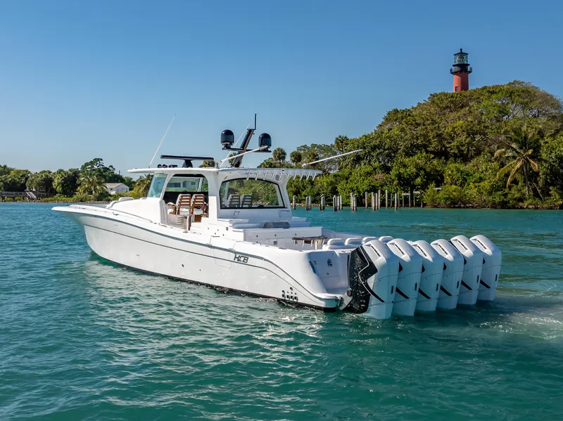 Slide: The Image of 2025 HCB 65 Estrella luxury boat cruising near a lighthouse. - 30