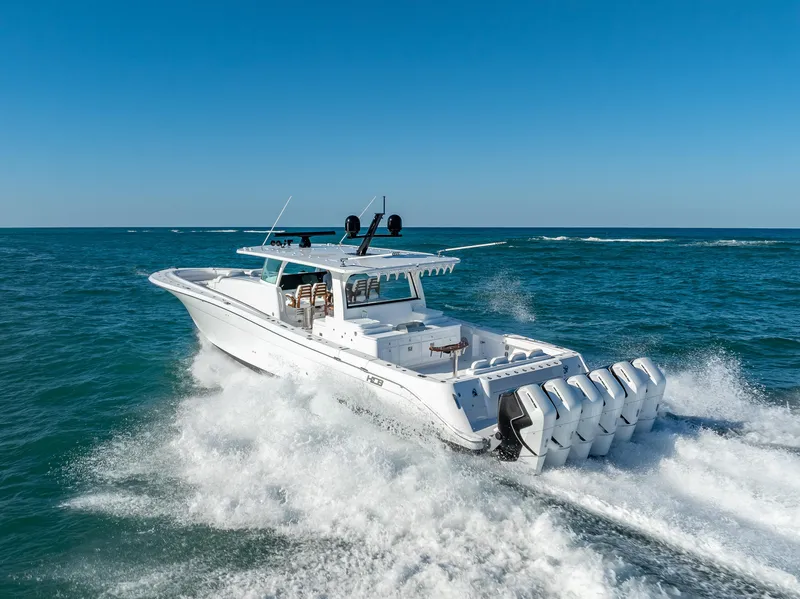 Slide: The Image of 2025 HCB 65 Estrella boat cruising on open sea with multiple outboard engines. - 31