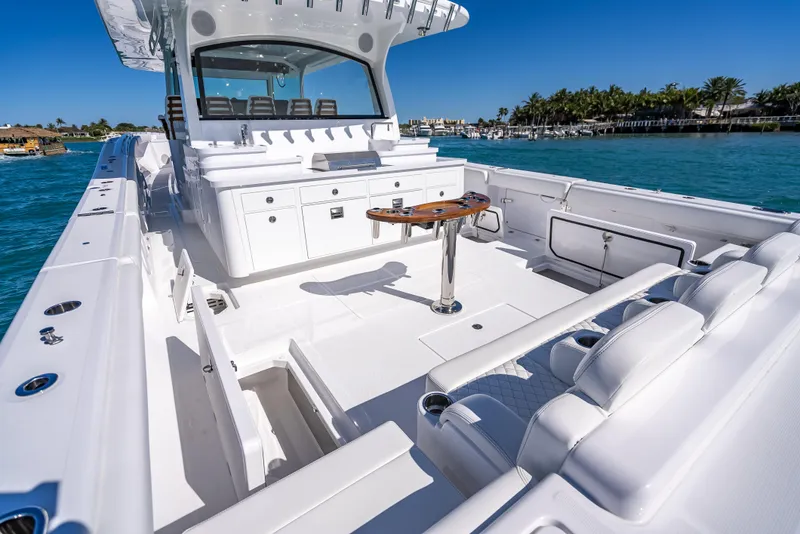 Slide: The Image of 2025 HCB 65 Estrella luxury boat interior with seating and table on a sunny day. - 7