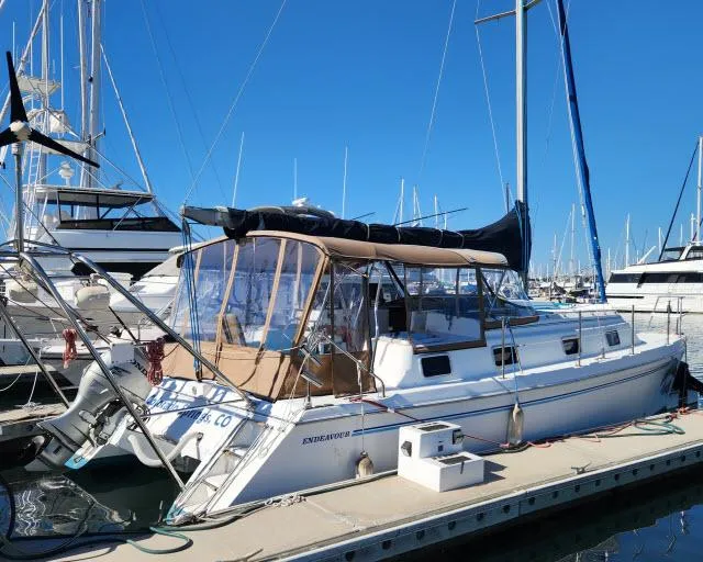 Slide: The Image of 1992 Endeavourcat 30 catamaran docked at marina under clear blue sky. - 1