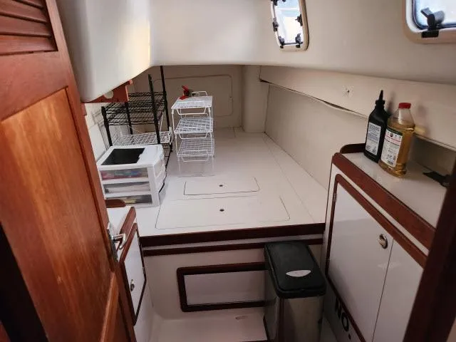 Slide: The Image of Interior of 1992 Endeavourcat 30 catamaran with storage shelves and cabinets. - 11