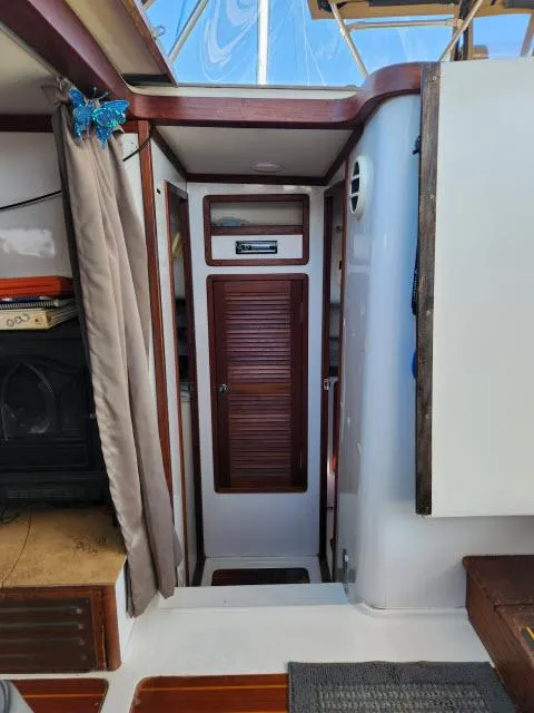 Slide: The Image of Interior of 1992 Endeavourcat 30 catamaran with wooden accents and cozy cabin space. - 12