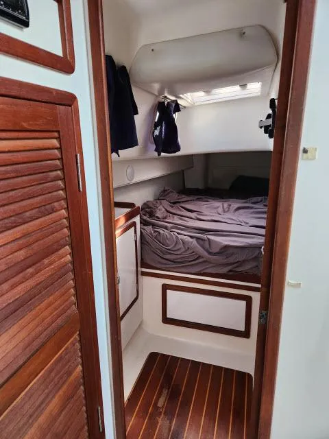 Slide: The Image of Cozy cabin interior of 1992 Endeavourcat 30 catamaran with wooden accents and bed. - 13