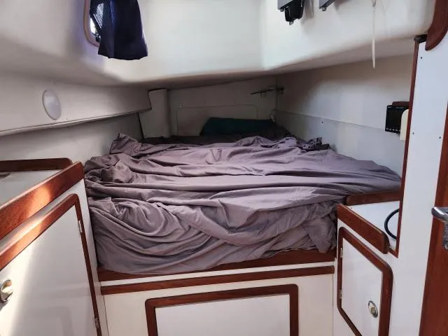 Slide: The Image of Cozy cabin interior of 1992 Endeavourcat 30 catamaran with unmade bed. - 14