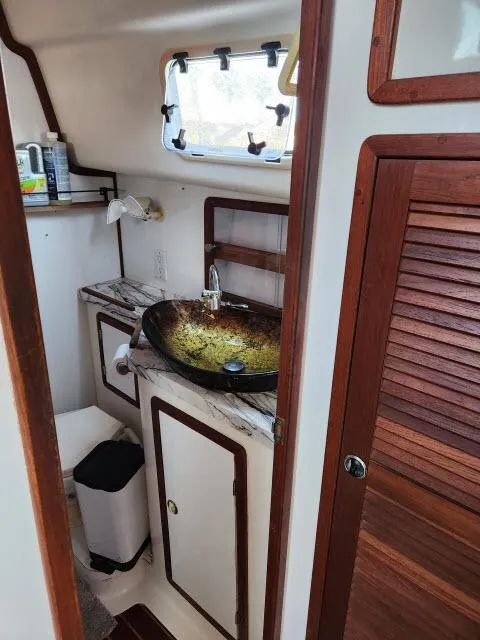 Slide: The Image of Bathroom interior of 1992 Endeavourcat 30 catamaran with wooden accents and modern sink. - 15