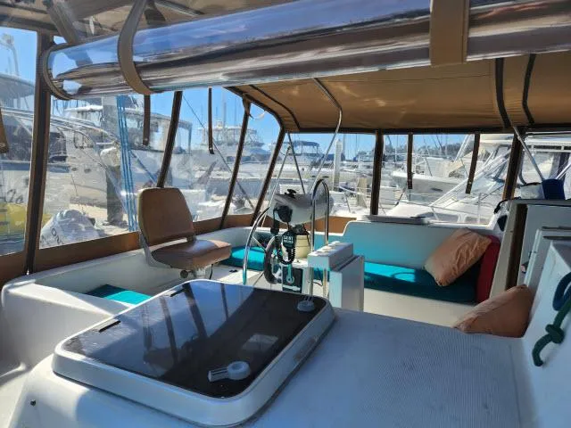 Slide: The Image of 1992 Endeavour Catamaran Endeavourcat 30 interior with seating and helm, docked at marina. - 19