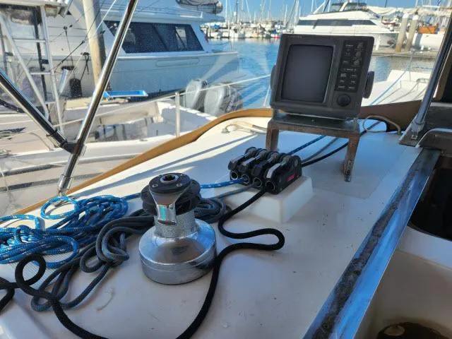 Slide: The Image of 1992 Endeavour Catamaran Endeavourcat 30 cockpit with navigation equipment and ropes in a marina. - 25