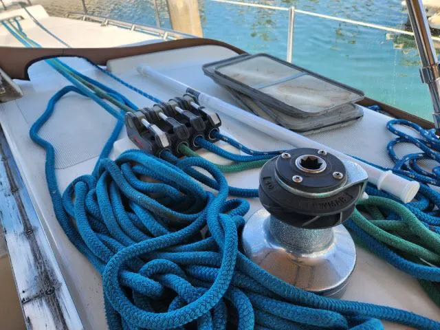 Slide: The Image of Deck of 1992 Endeavourcat 30 with ropes and winch, docked by the water. - 26