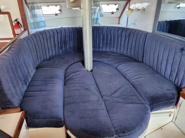 Slide: The Image of 1992 Endeavourcat 30 interior with blue cushioned seating in a cozy, circular arrangement. - 3