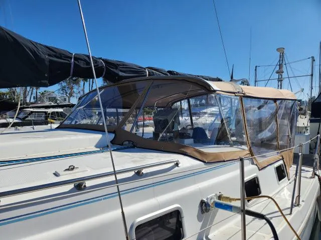 Slide: The Image of 1992 Endeavourcat 30 catamaran docked, featuring a tan canopy and sleek design. - 30