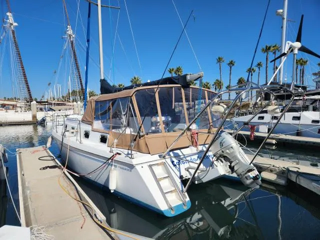 Slide: The Image of 1992 Endeavourcat 30 catamaran docked at marina under clear blue sky. - 33