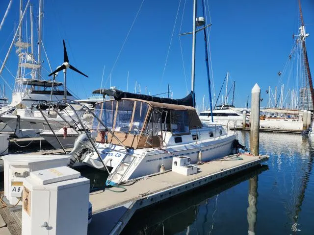 Slide: The Image of 1992 Endeavourcat 30 catamaran docked at marina, clear blue sky, surrounded by other boats. - 34