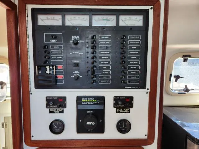 Slide: The Image of Control panel of a 1992 Endeavour Catamaran Endeavourcat 30, featuring gauges and switches. - 8