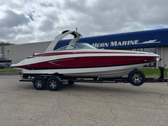 The Image of 2025 Crownline 280 SS boat on trailer, parked outside marine dealership. - 1