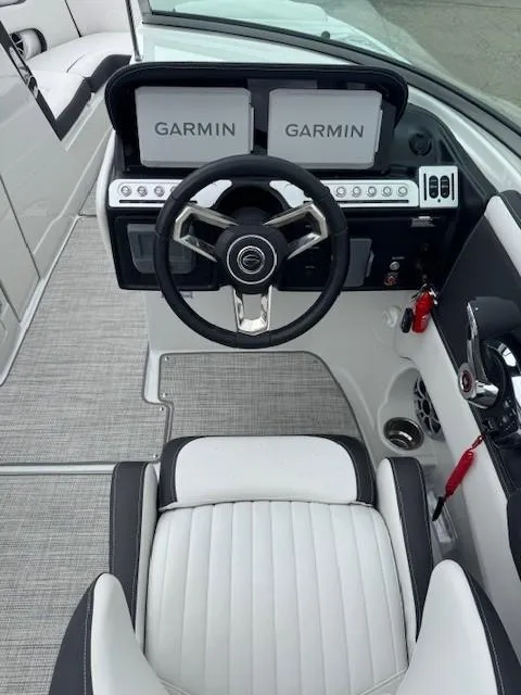 Slide: The Image of 2025 Crownline 280 SS boat cockpit with Garmin navigation system and sleek steering wheel. - 11