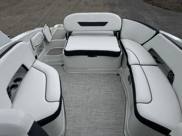 Slide: The Image of 2025 Crownline 280 SS boat interior with white cushioned seating and gray flooring. - 16