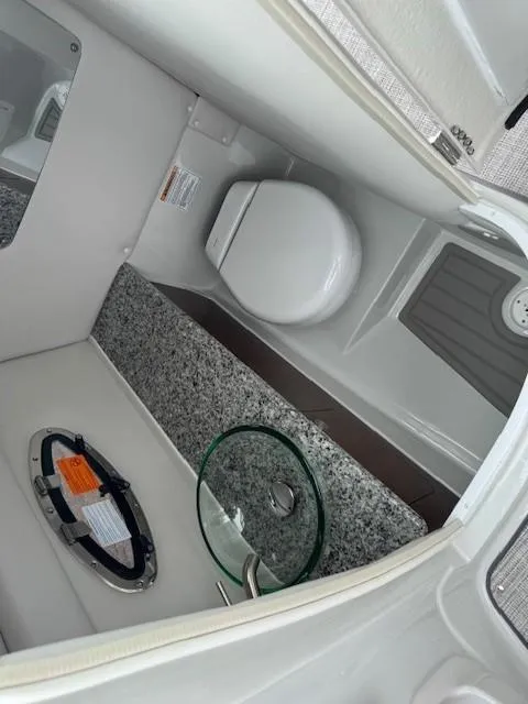 Slide: The Image of 2025 Crownline 280 SS boat interior with modern bathroom amenities and sleek design. - 17