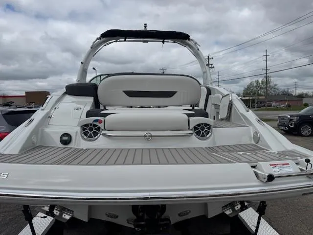 Slide: The Image of 2025 Crownline 280 SS boat with sleek design and spacious seating on a cloudy day. - 5