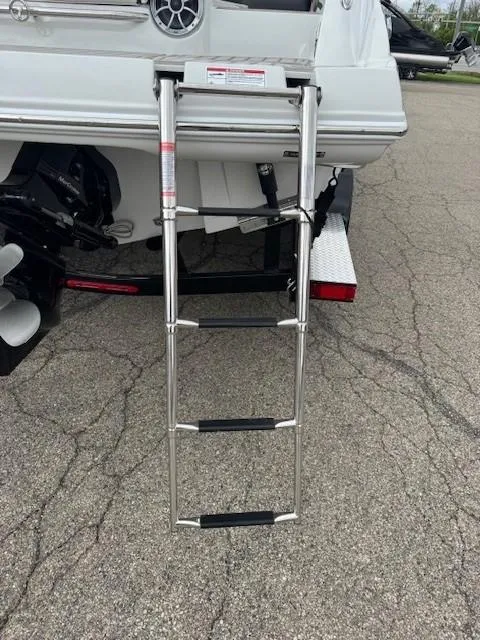 Slide: The Image of 2025 Crownline 280 SS boat with extended swim ladder on a trailer. - 8
