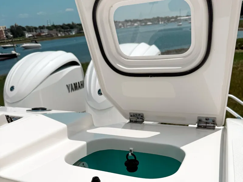 Slide: The Image of 2022 Pursuit S 328 Sport boat with Yamaha engines, open hatch, and scenic waterfront view. - 11